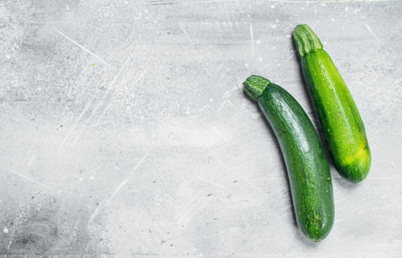 Whole ripe zucchini. On white rustic backgroundの写真素材