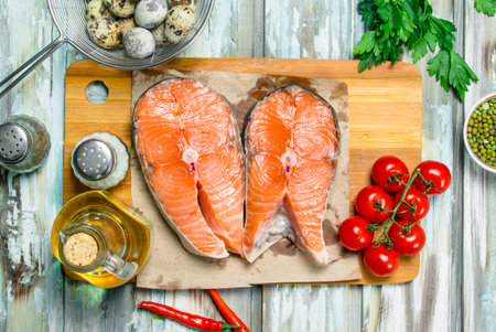 Health food. Salmon steaks with organic food. On a rustic background.の写真素材