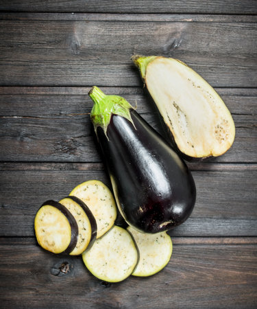 Pieces of fresh eggplant. On wooden backgroundの写真素材