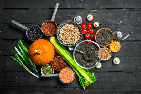 organic food. Different range of fruits and vegetables with legumes. On a black rustic background.の写真素材