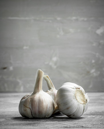 Fragrant fresh garlic. On rustic backgroundの写真素材