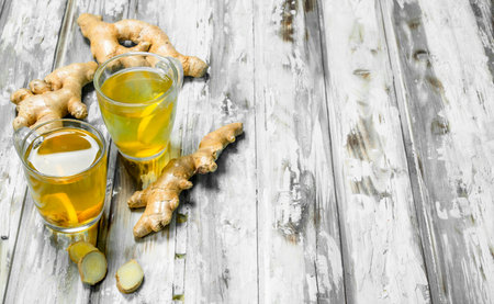Ginger tea and fresh ginger. On wooden backgroundの写真素材