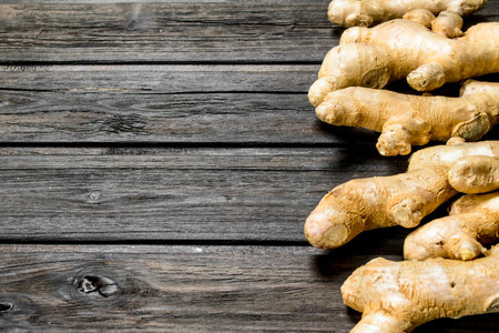 Fresh fragrant ginger. On black wooden backgroundの写真素材