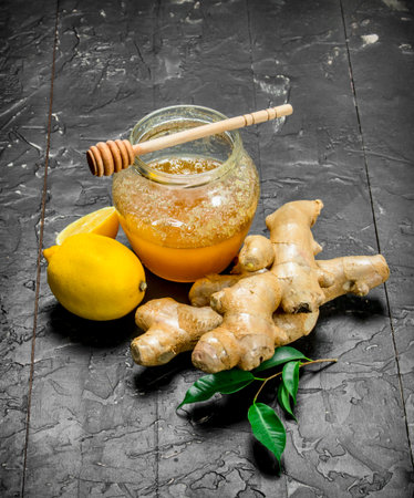 Ginger with lemon and honey. On black rustic backgroundの写真素材