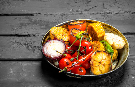 Grilled vegetables in a pan. On a black rustic background.の写真素材
