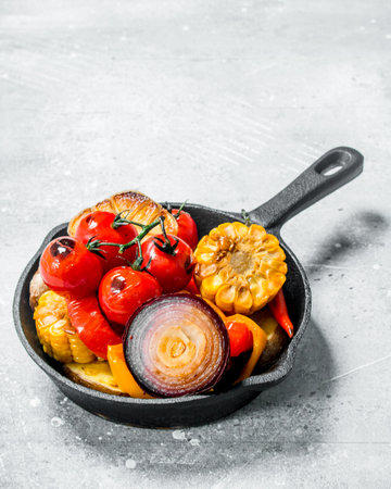 Grilled vegetables in a pan with spices. On a rustic background.の写真素材