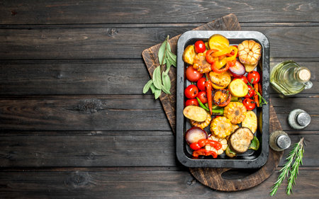 Different grilled vegetables with herbs and spices. On a wooden background.の写真素材