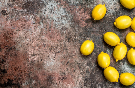 Fresh juicy lemons. On rustic backgroundの写真素材