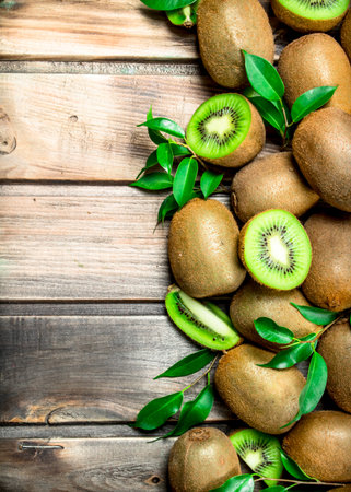 Kiwi slices with leaves. On wooden backgroundの写真素材