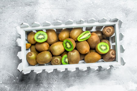 Ripe kiwi in the box. On rustic backgroundの写真素材