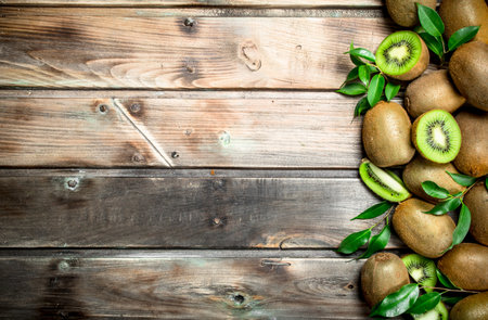 Kiwi slices with leaves. On wooden backgroundの写真素材