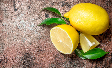 Ripe lemons with leaves. On rustic backgroundの写真素材