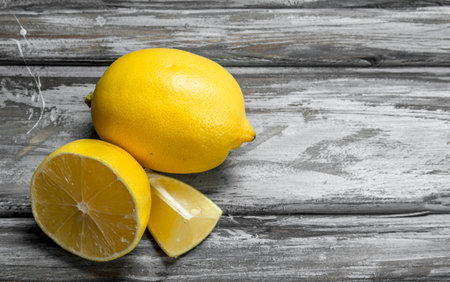 Fresh juicy lemons. On wooden backgroundの写真素材