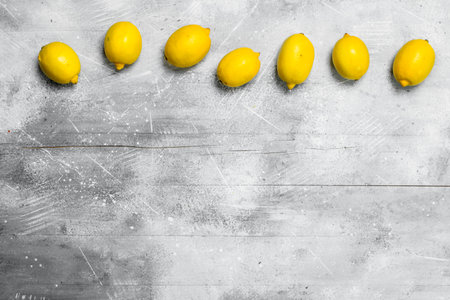 fresh ripe lemons. On rustic backgroundの写真素材