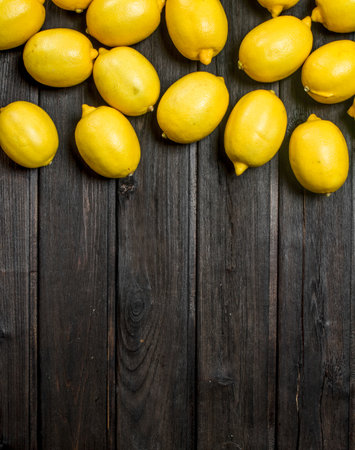 Delicious fresh lemons. On wooden backgroundの写真素材