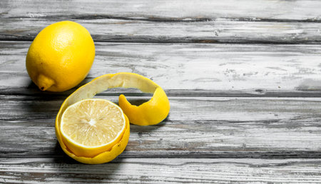 Ripe lemon zest. On wooden background