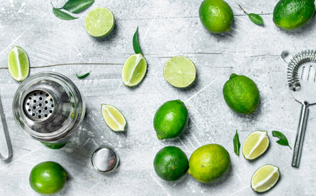 Shaker and fresh juicy lime. On rustic backgroundの写真素材