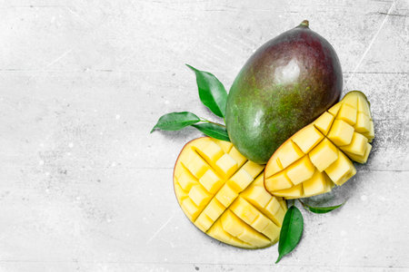 Fresh mango with leaves. On white rustic backgroundの写真素材