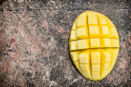 Ripe cut mango. On rustic backgroundの写真素材