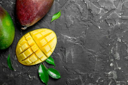 Fragrant ripe mango. On black rustic backgroundの写真素材
