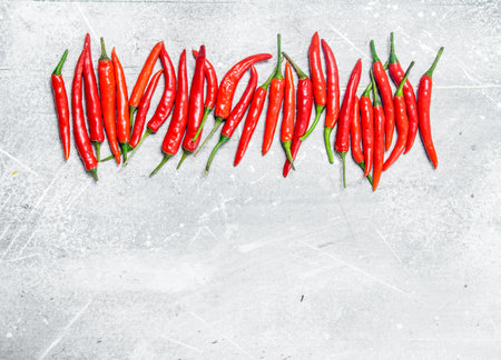 Fresh red hot pepper. On white rustic backgroundの写真素材