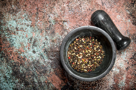 Pepper peas in a mortar and pestle. On rustic backgroundの写真素材