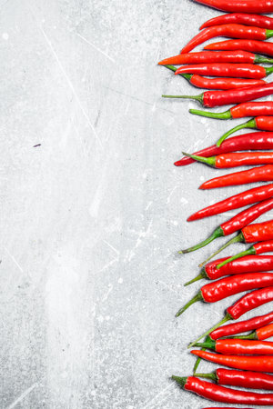 Fresh red hot pepper. On white rustic backgroundの写真素材