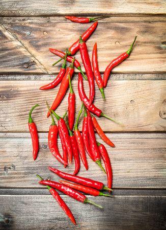 Ripe hot pepper. On wooden backgroundの写真素材