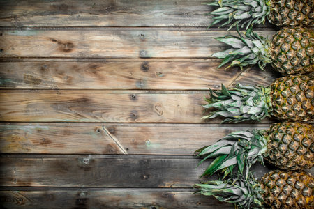 Fresh fragrant pineapple. On wooden backgroundの写真素材