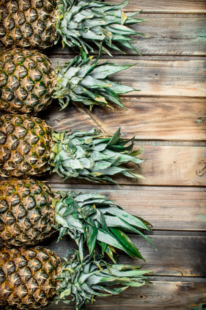 Fresh fragrant pineapple. On wooden backgroundの写真素材
