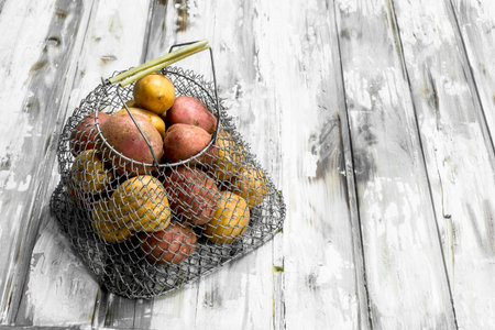 Fries in metal basket. On white wooden backgroundの写真素材