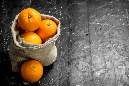 Fresh oranges in the sack. On rustic backgroundの写真素材