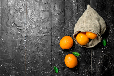 Fresh oranges in the sack. On rustic backgroundの写真素材