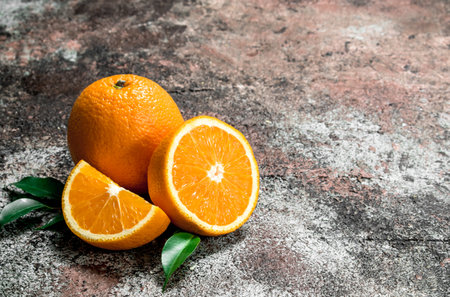 Pieces of fresh oranges. On rustic backgroundの写真素材
