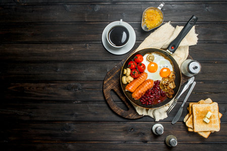 Traditional English Breakfast with a variety of food and aromatic coffee. On a wooden background.の写真素材