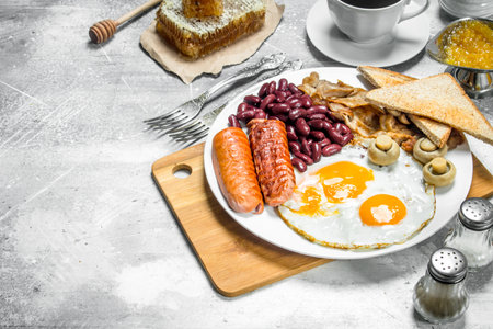 English breakfast. A variety of snacks with aromatic coffee. On a rustic background.の写真素材
