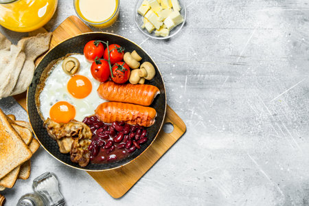 English breakfast. A variety of snacks with orange juice. On a rustic background.の写真素材