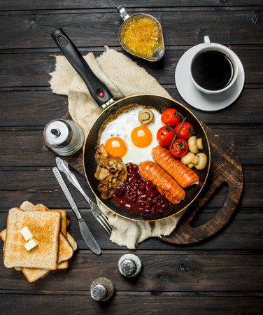 Traditional English Breakfast with a variety of food and aromatic coffee. On a wooden background.の写真素材