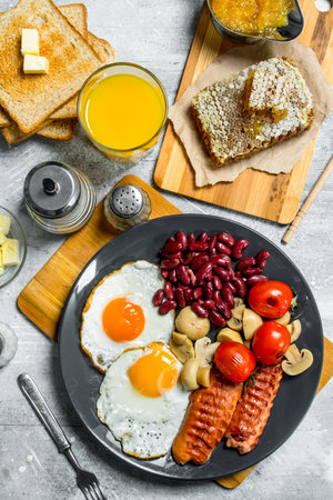 English breakfast. A variety of snacks with orange juice. On a rustic background.の写真素材