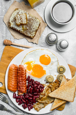 English breakfast. A variety of snacks with aromatic coffee. On a rustic background.の写真素材
