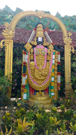 Hindu god lord venkateswara statue with full of greeneryの写真素材