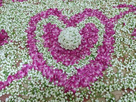 heart shape made with jasmine and rose petals combination and jasminee ball in the middleの写真素材