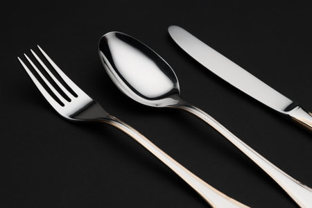 metal cutlery on black background