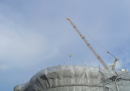 crane near building on Cloudy sky backgroundの写真素材