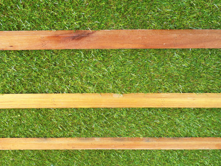 Background: Wooden plate with the green grass for designerの写真素材