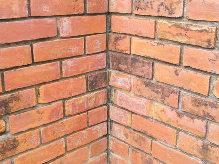 Old grunge brick wall background in orangeの写真素材