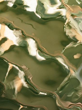 Abstract colorful reflection in rippled water surfaceの写真素材