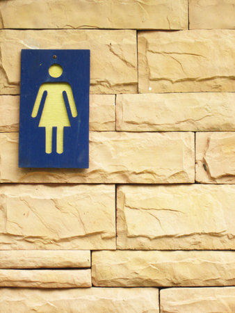 Ladies bathroom sign on a brick wallの写真素材