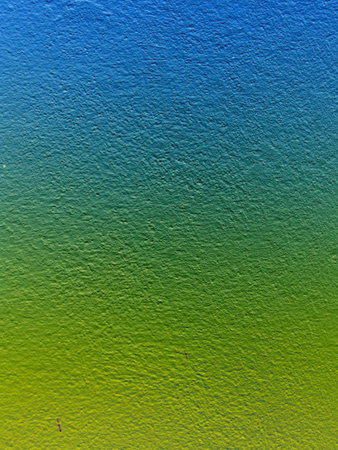Blue, yellow, green cement wallの写真素材