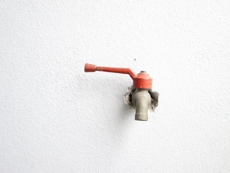 Closeup faucet on concrete white wall backgroundの写真素材